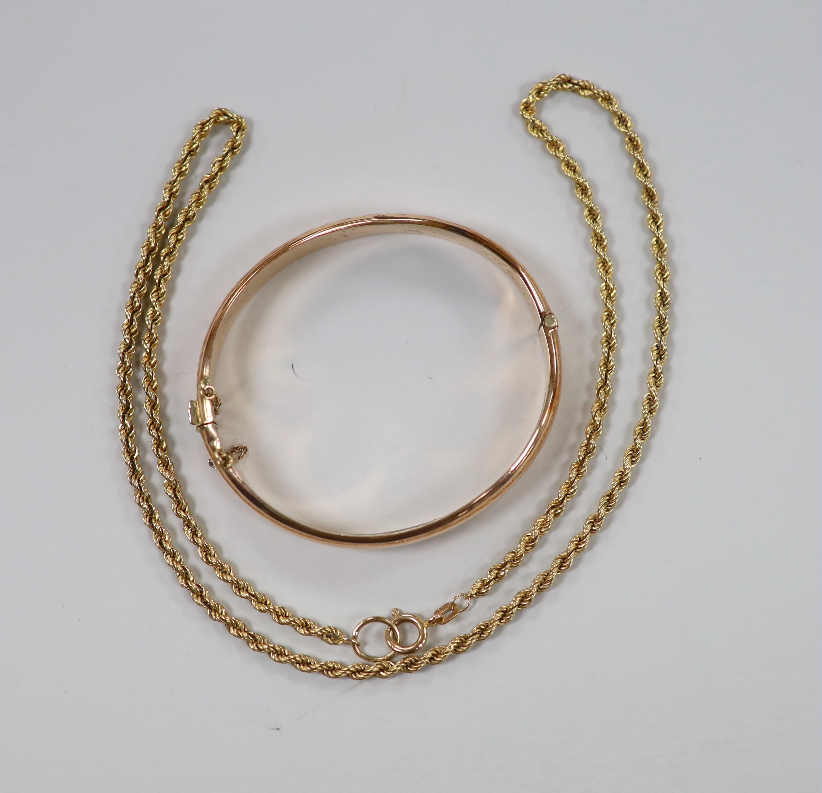 A modern 9ct gold ropetwist chain, 52cm and a 9ct gold hinged bangle, 19.7 grams.